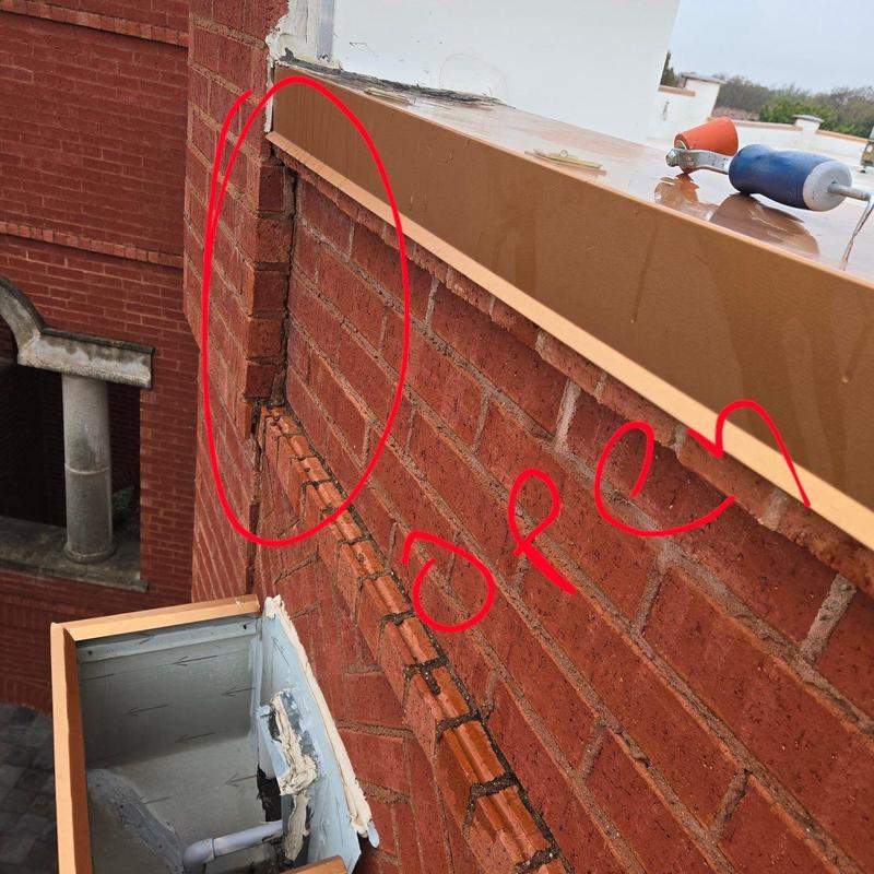Brick wall mortar joint damage near metal coping edge Brick wall mortar joint damage near metal coping edge