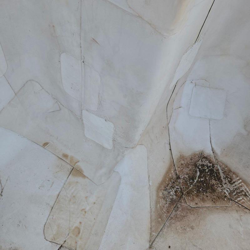 TPO roofing membrane with patches and damage spots TPO roofing membrane with patches and damage spots