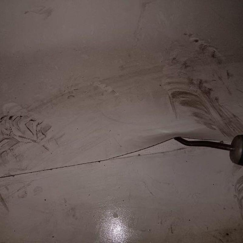 Floor drain with metal grate and surrounding stains Floor drain with metal grate and surrounding stains