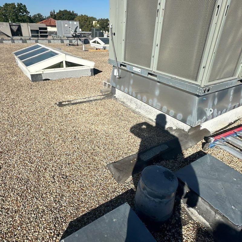 Commercial roofing gravel surface with HVAC unit base Commercial roofing gravel surface with HVAC unit base