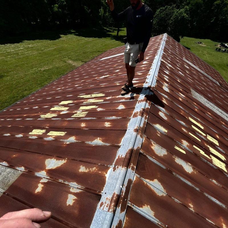 Metal roof rust and damage inspection on residential roof