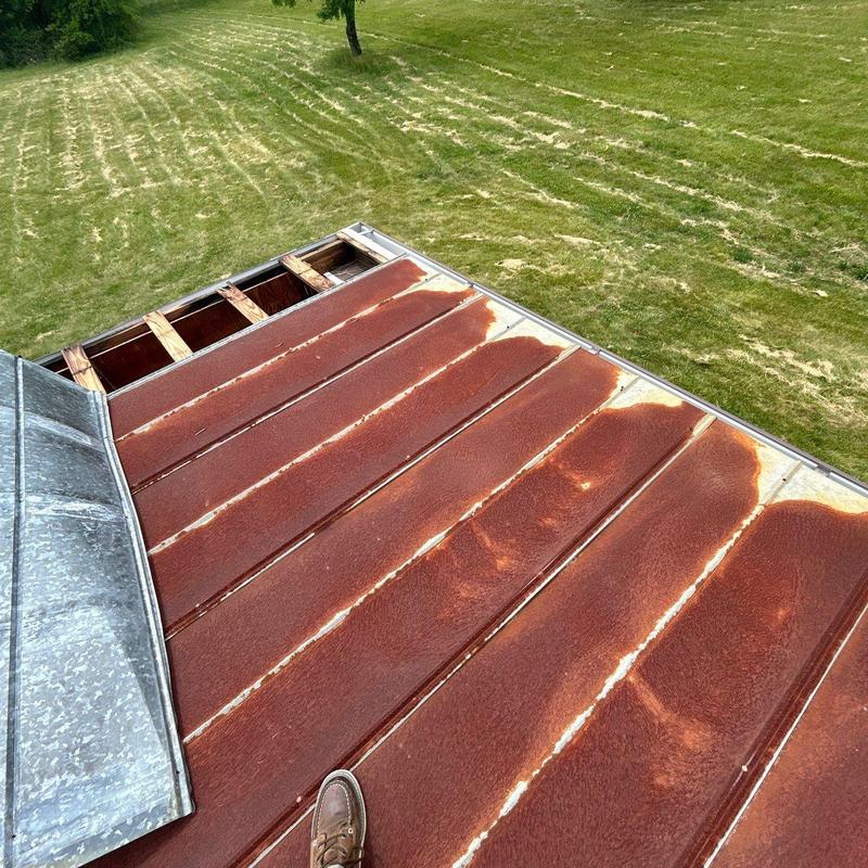 Metal roof panels with rust and edge damage inspection
