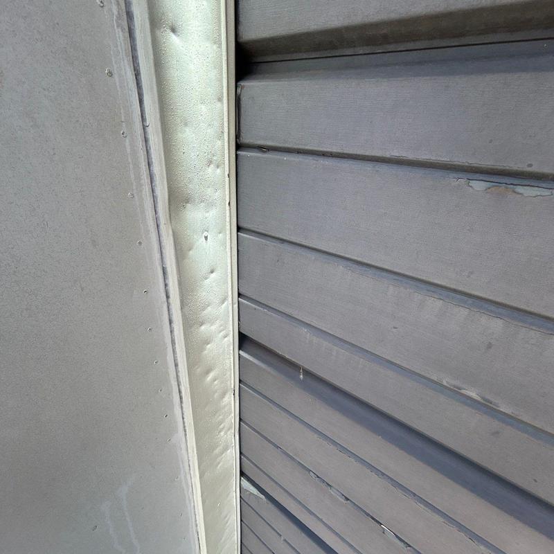Metal roof flashing with hail damage dents