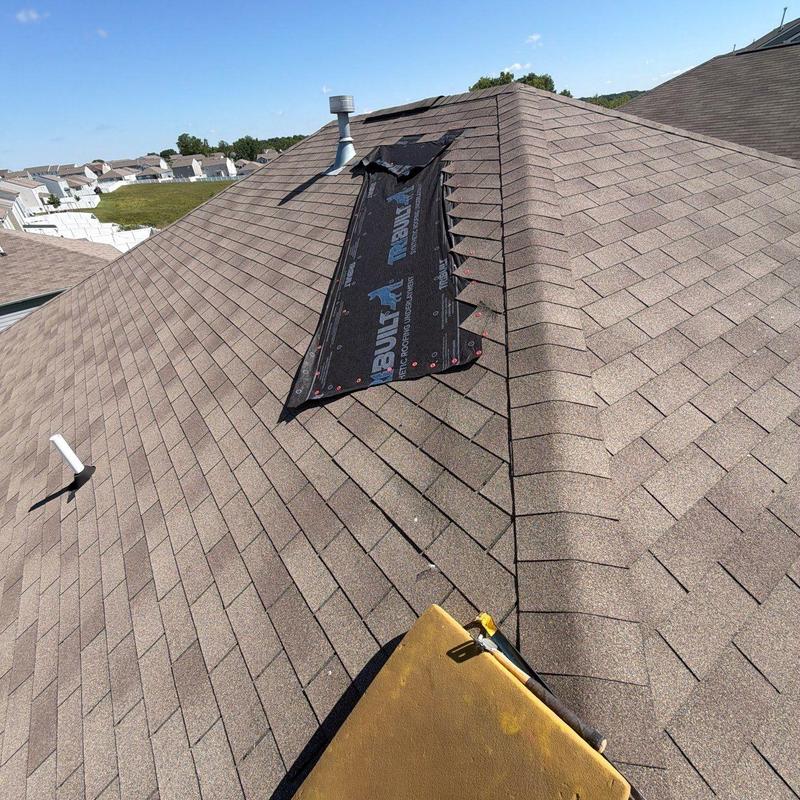 Roof ridge underlayment exposed for shingle replacement