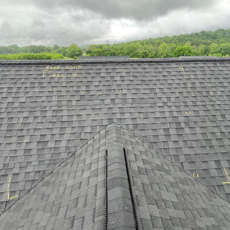 Asphalt shingle roof with marked hail damage spots