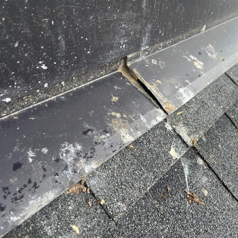 Metal roof flashing with visible separation gap