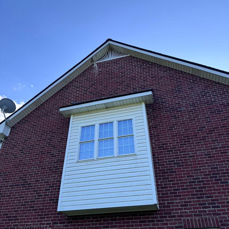 Roof gable and siding inspection on brick home