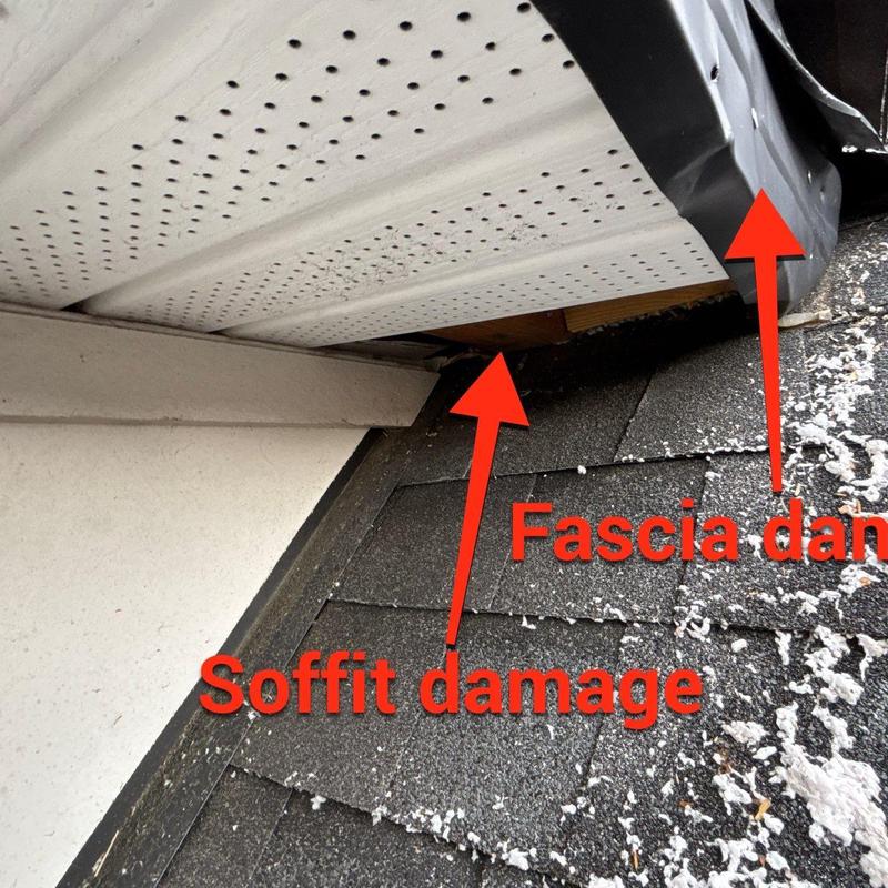 Soffit and fascia damage on roof edge showing wear