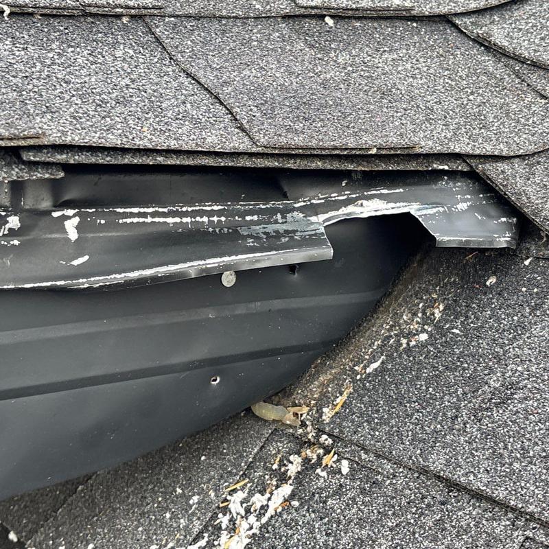Roof flashing showing wear and damage from hail
