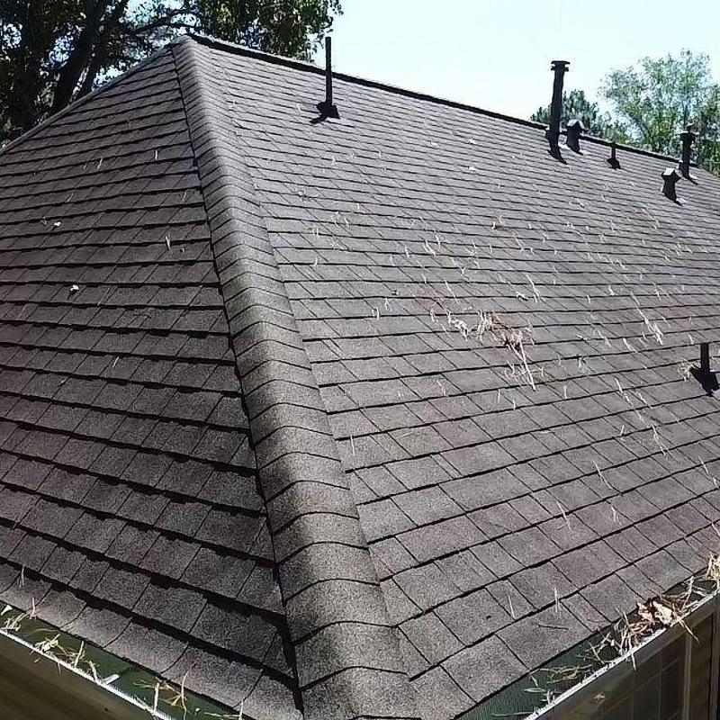 Asphalt shingle roof with sealed pipe boots and ridge cap