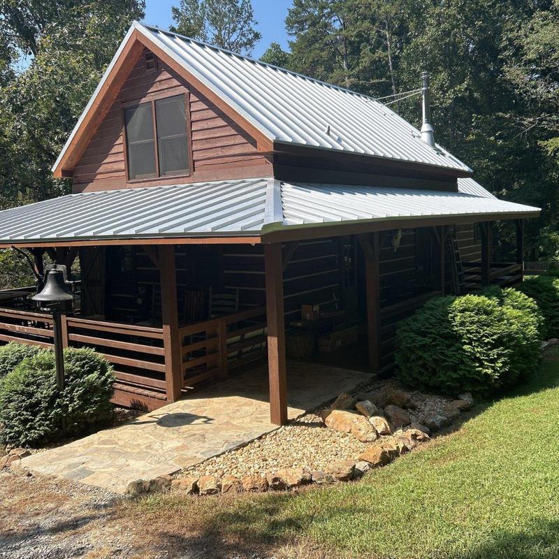 Standing seam metal roof on log home and porch Standing seam metal roof on log home and porch