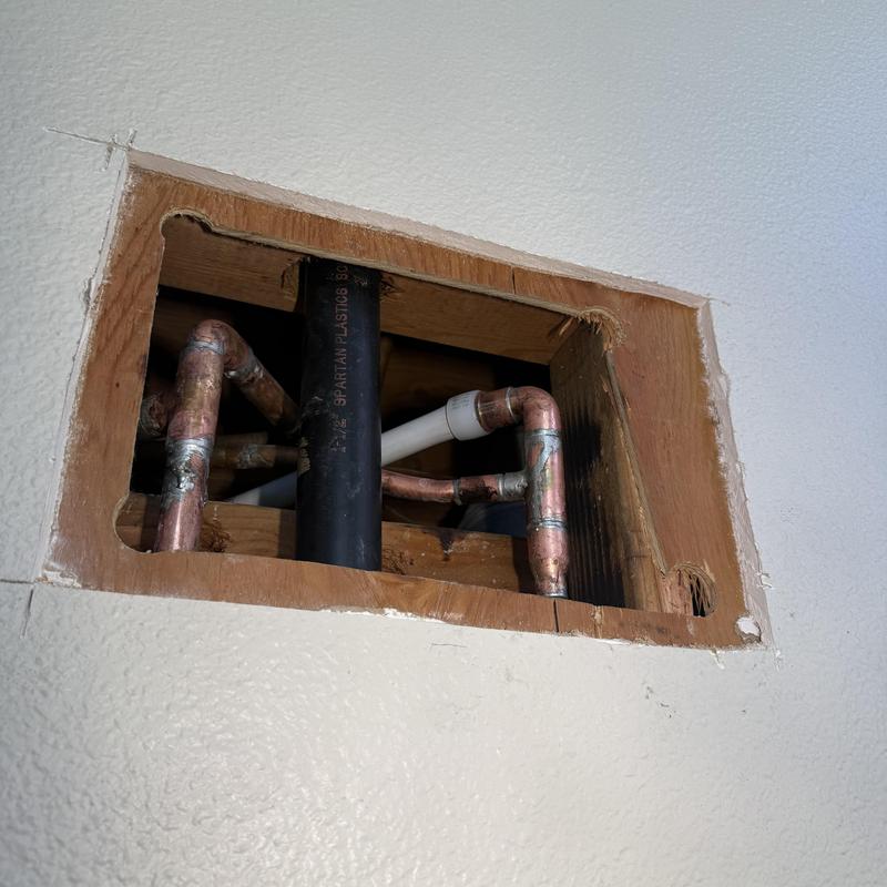 Copper water piping and drain pipe in ceiling cavity