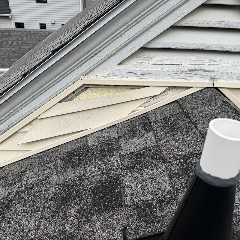 Siding displaced and peeling paint above asphalt shingles Siding displaced and peeling paint above asphalt shingles