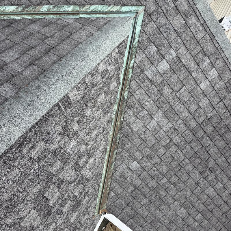 Copper valley flashing on gray asphalt shingle roof Copper valley flashing on gray asphalt shingle roof