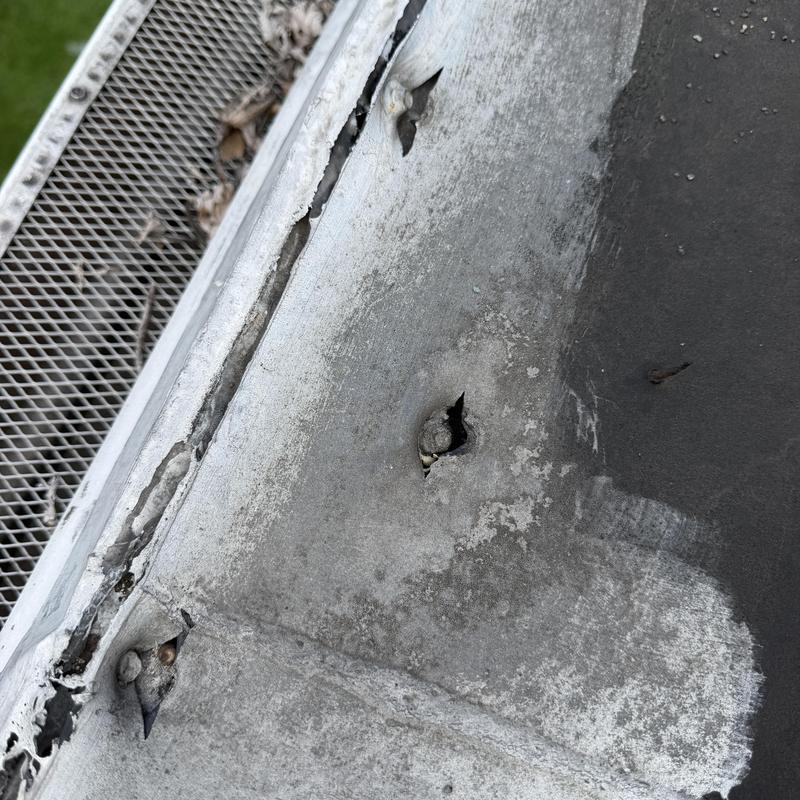 EPDM rubber roof with puncture and damaged seam EPDM rubber roof with puncture and damaged seam