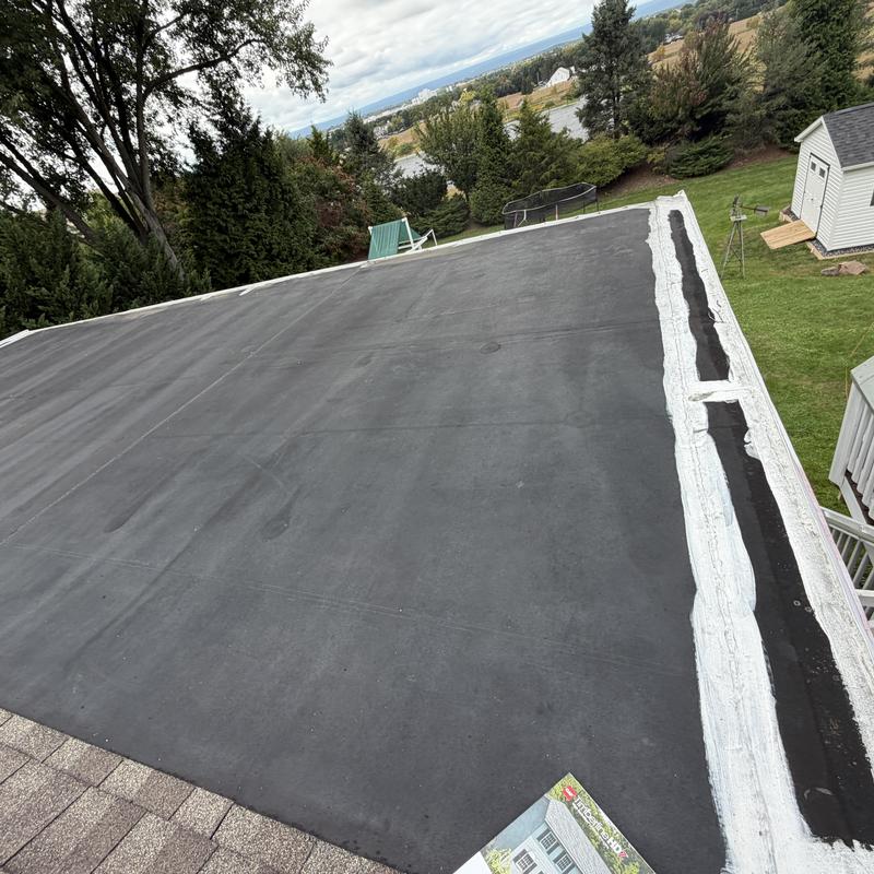 EPDM rubber roof with sealed edges and patch repairs EPDM rubber roof with sealed edges and patch repairs