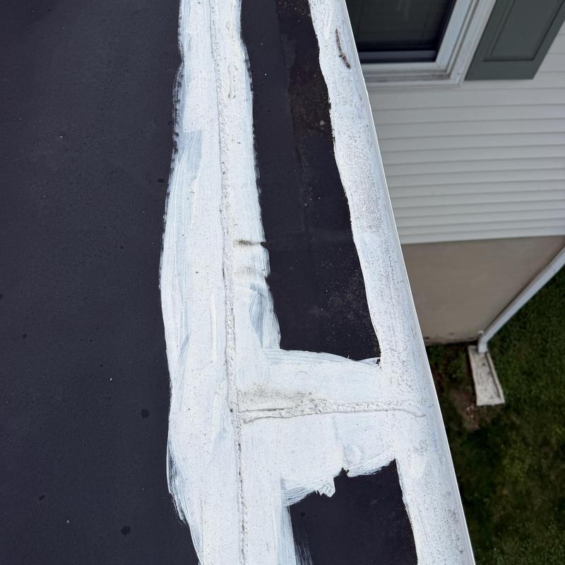 EPDM rubber roof membrane pulled back from edge EPDM rubber roof membrane pulled back from edge