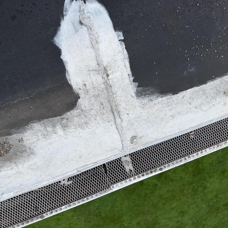 EPDM rubber roof section with white seam patch and gutter edge EPDM rubber roof section with white seam patch and gutter edge