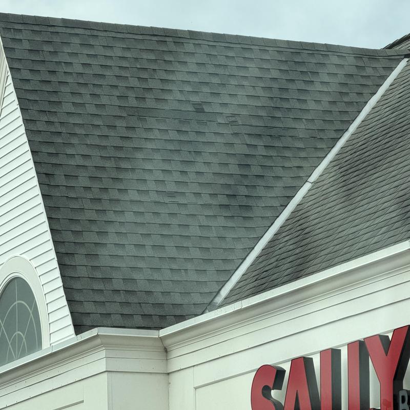 Commercial asphalt shingle roof with wind damage and prior repairs Commercial asphalt shingle roof with wind damage and prior repairs