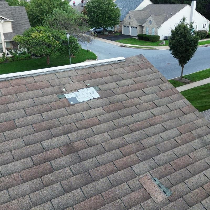 Asphalt shingle roof with wind damage and measurement tile Asphalt shingle roof with wind damage and measurement tile