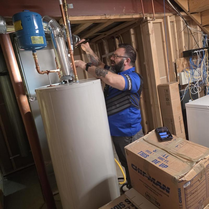Water heater system flushing in basement utility area