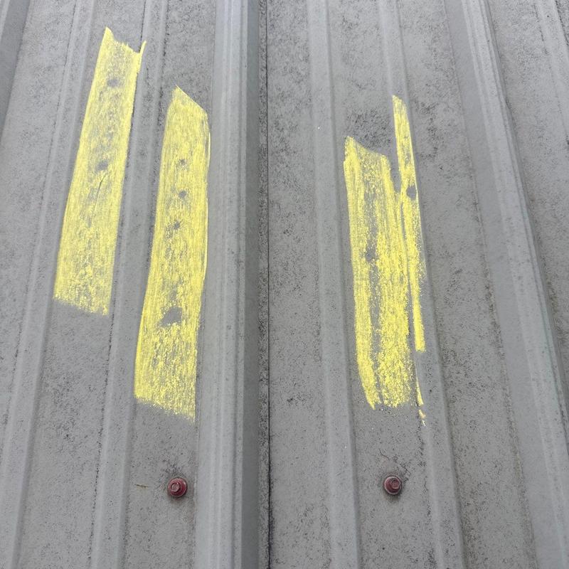 Metal roof panels with marked hail damage areas