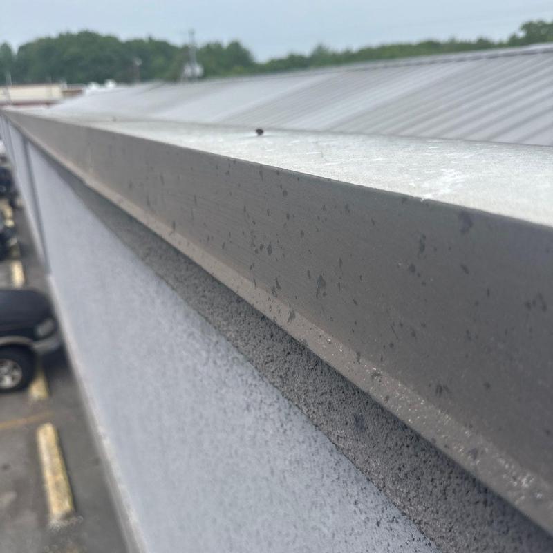 Metal roof edge flashing with storm wear and damage