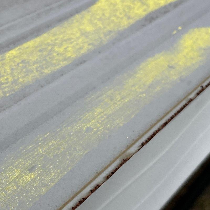 Metal roof panel rust along edge close-up