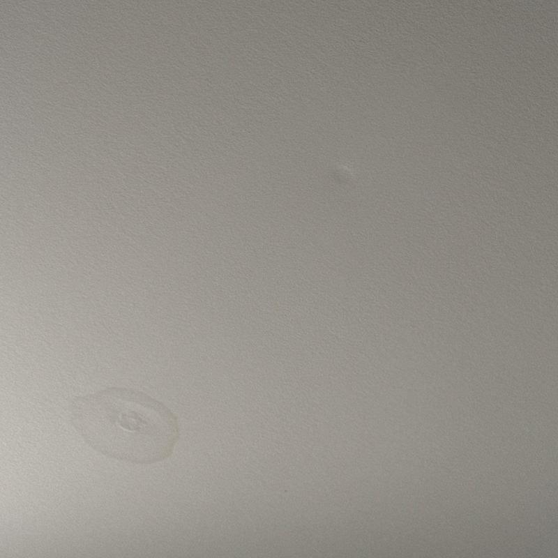 Ceiling water stain and small indentation damage