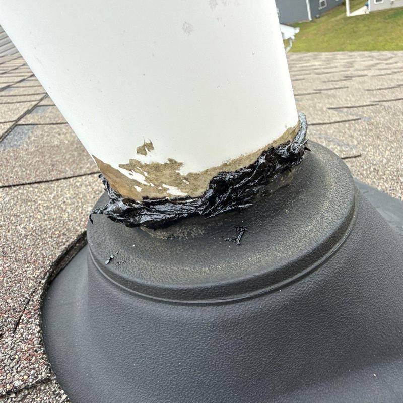 Roof vent pipe flashing with damaged sealant on shingles