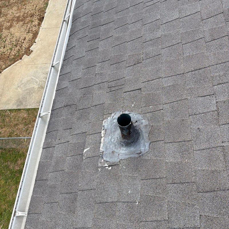 Roof vent pipe flashing with sealant on asphalt shingles