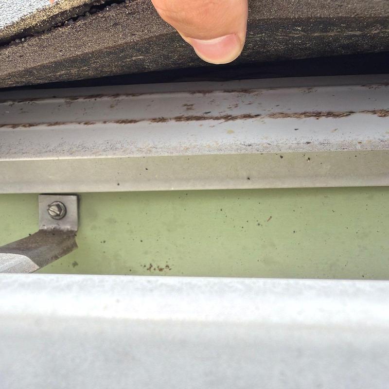 Roof underlayment lifted to inspect flashing and structure