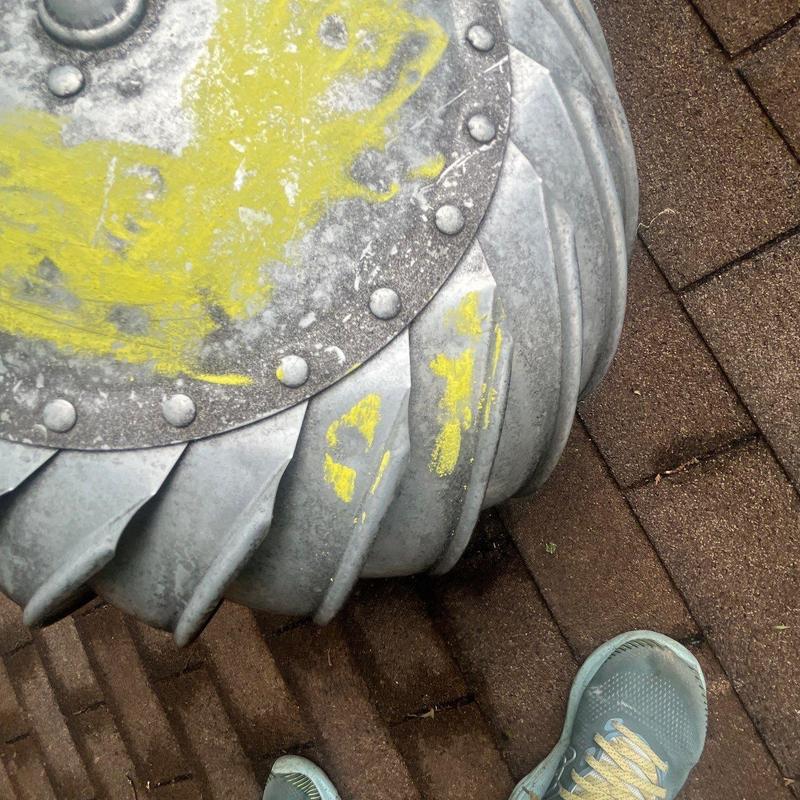 Roof turbine vent with yellow inspection marks on shingles