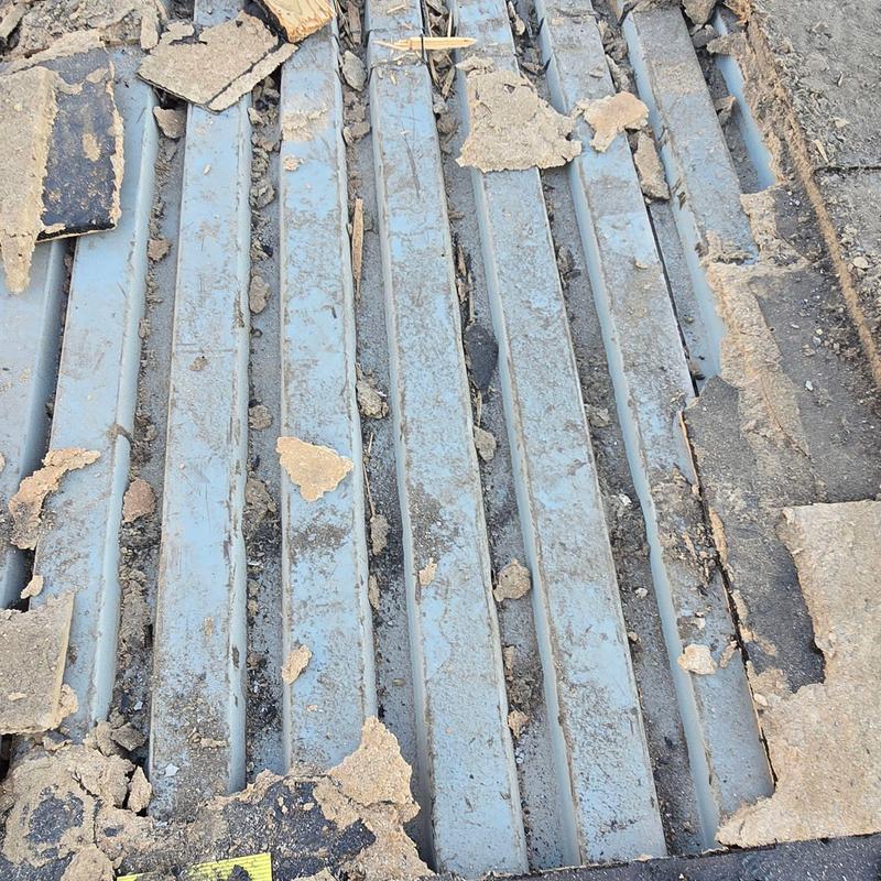 Concrete roofing deck with old material removal debris Concrete roofing deck with old material removal debris