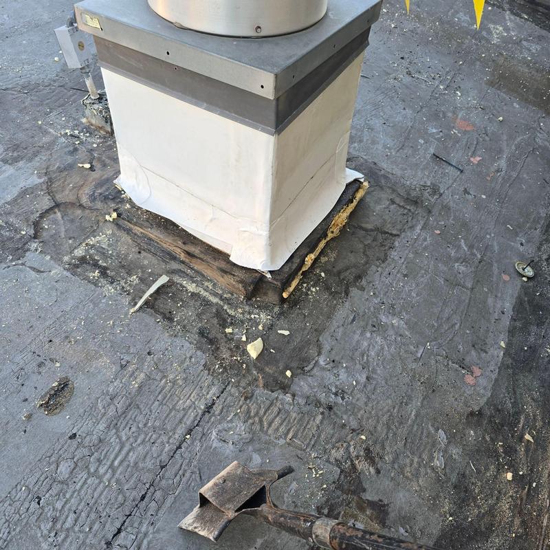 Roof vent base with damaged flashing on low-slope roof Roof vent base with damaged flashing on low-slope roof