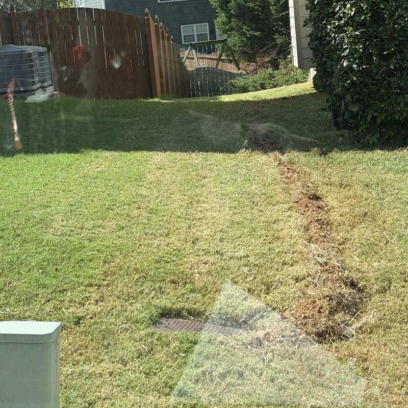 Water main trench excavation in residential lawn