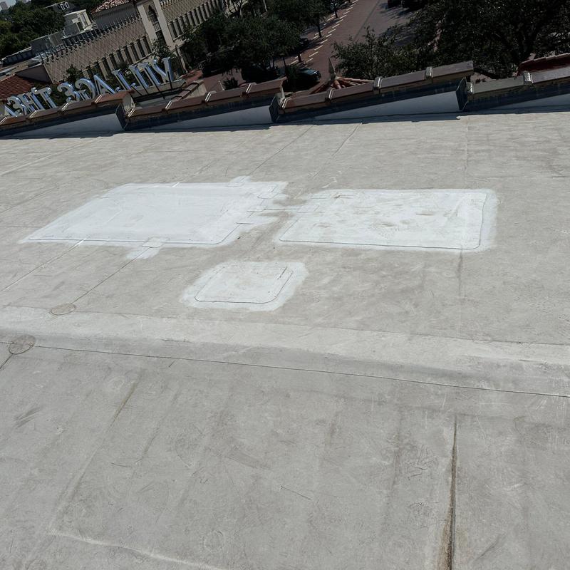 Concrete roof with patch repairs on commercial building Concrete roof with patch repairs on commercial building