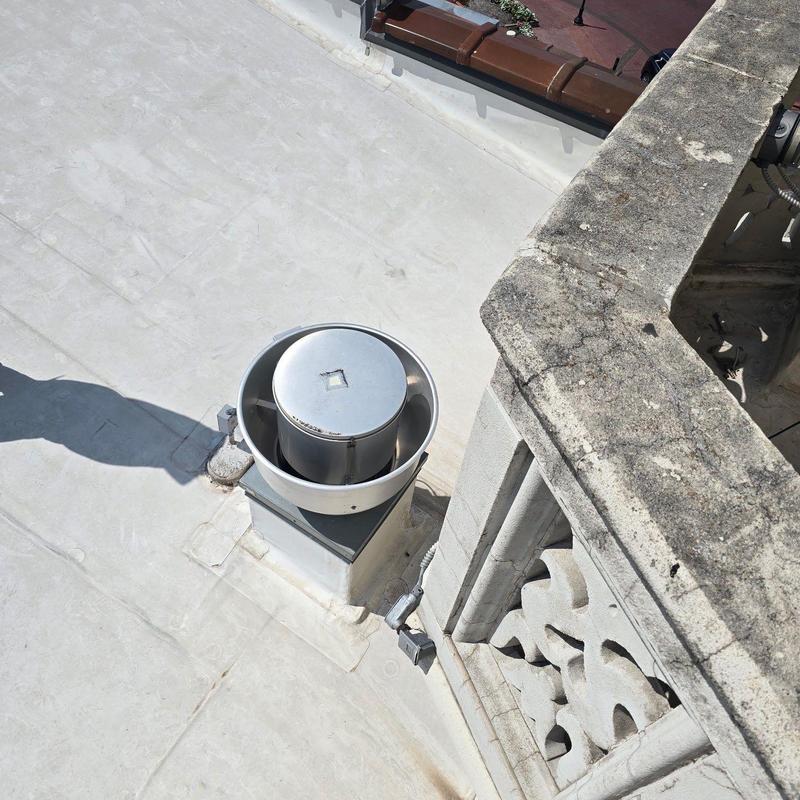 Roof vent on concrete roof near parapet wall Roof vent on concrete roof near parapet wall