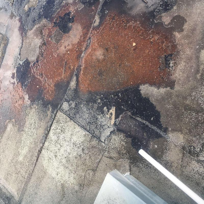 Concrete commercial roof with damage and wear Concrete commercial roof with damage and wear