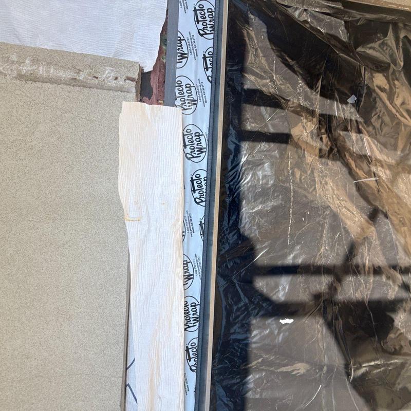 Stucco wall with protective wrap and waterproofing Stucco wall with protective wrap and waterproofing