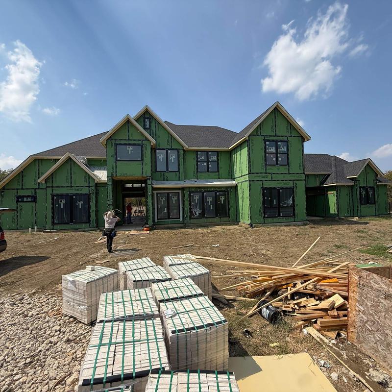 House sheathing installation with construction materials on site House sheathing installation with construction materials on site