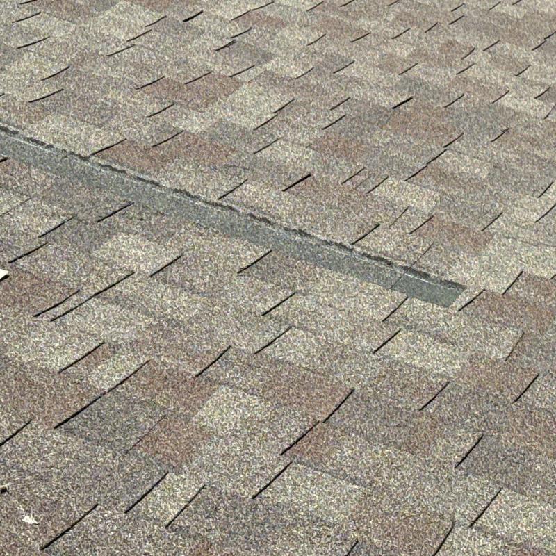 Asphalt shingle roof with hail damage repair Asphalt shingle roof with hail damage repair