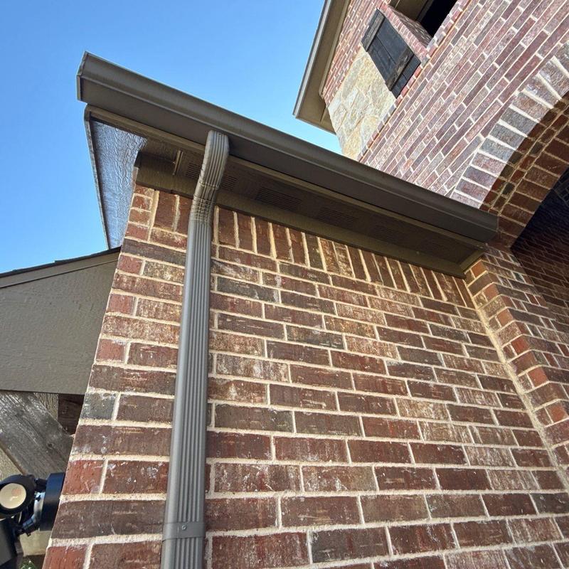 Rain gutter and downspout installation on brick wall Rain gutter and downspout installation on brick wall