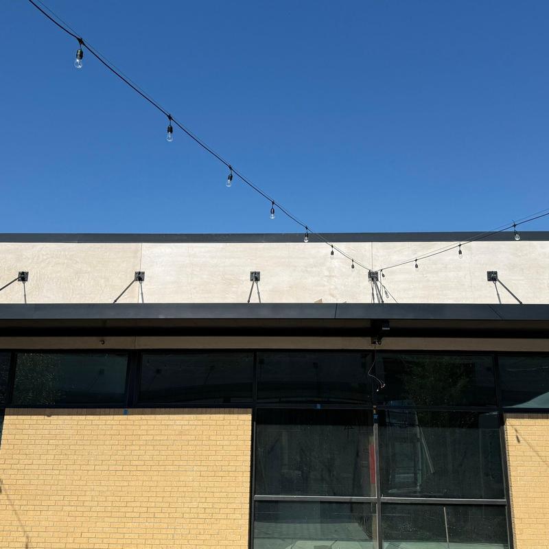 Concrete wall leak and crack repair with string lights above Concrete wall leak and crack repair with string lights above