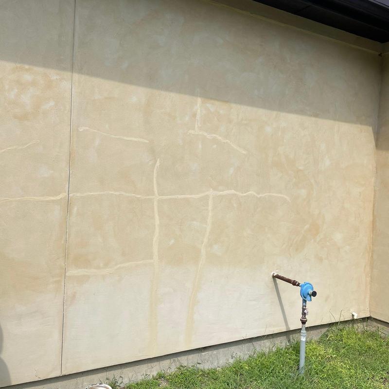 Stucco wall surface with patch repair and water meter Stucco wall surface with patch repair and water meter