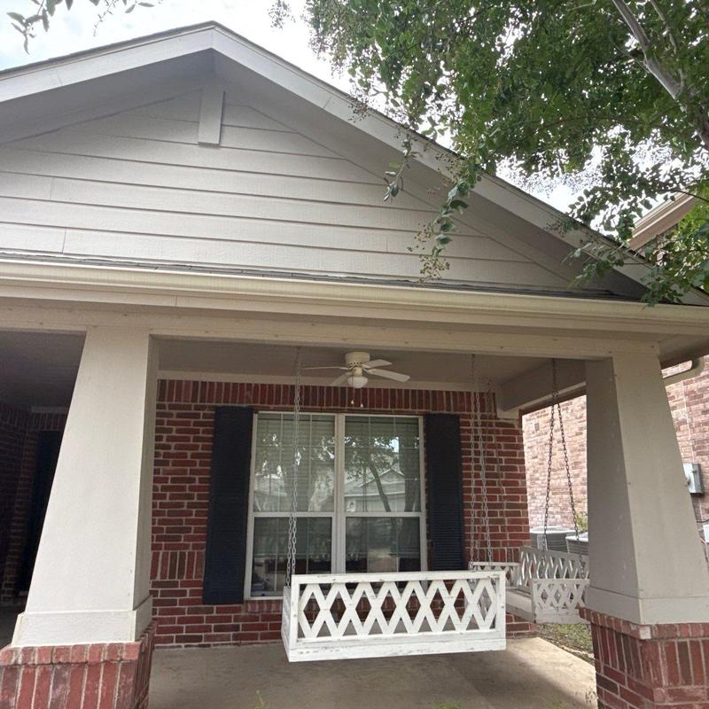 Shingle roof and porch swing at brick home Shingle roof and porch swing at brick home