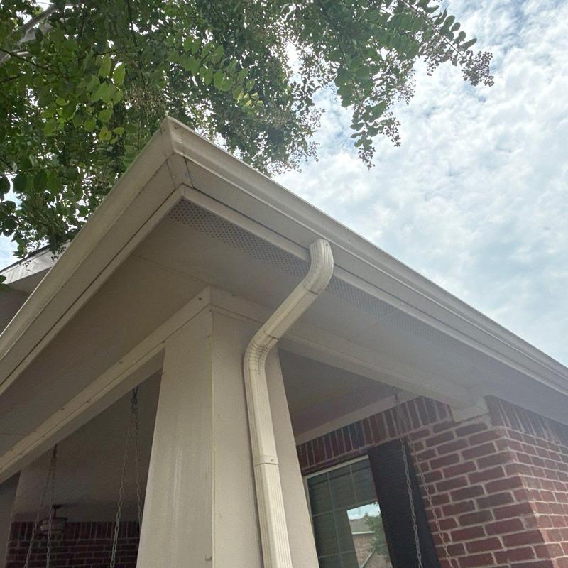 Seamless aluminum gutter and downspout on porch corner Seamless aluminum gutter and downspout on porch corner