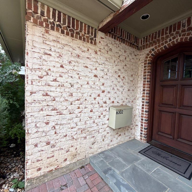 Brick wall exterior with mailbox and front door entrance Brick wall exterior with mailbox and front door entrance