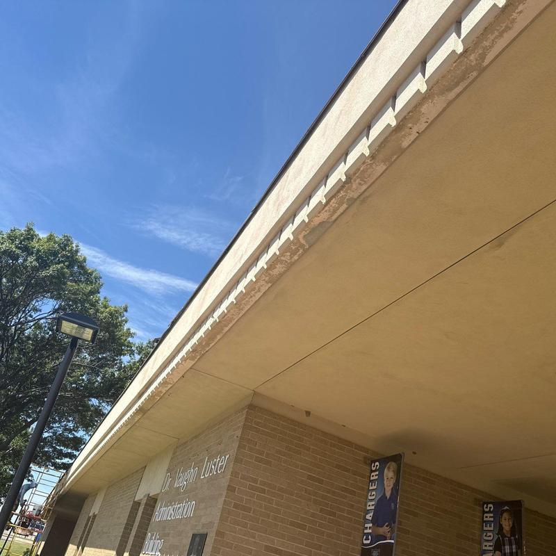 Concrete building fascia with stucco repair work Concrete building fascia with stucco repair work