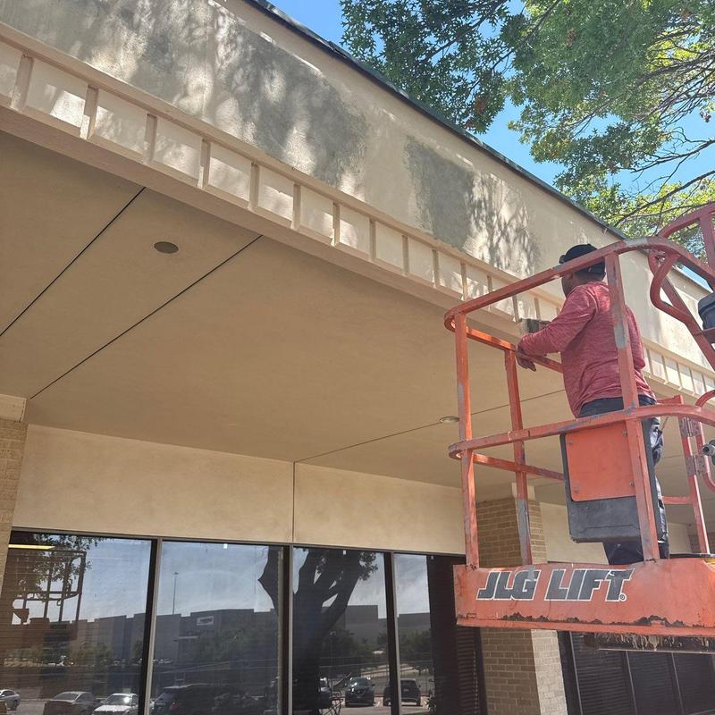 Concrete wall patching on building exterior with lift Concrete wall patching on building exterior with lift